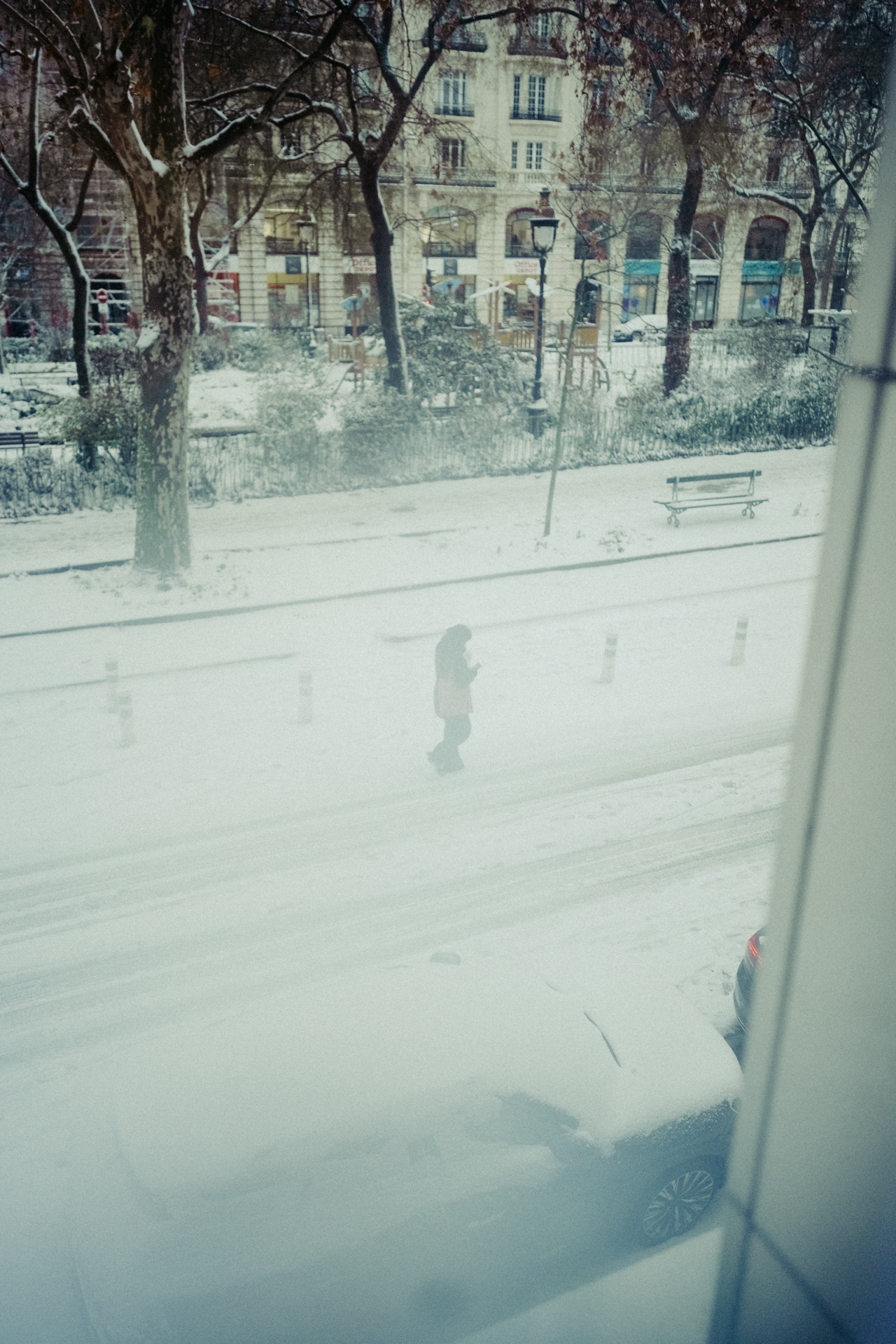 View through a window onto a snowy Paris street